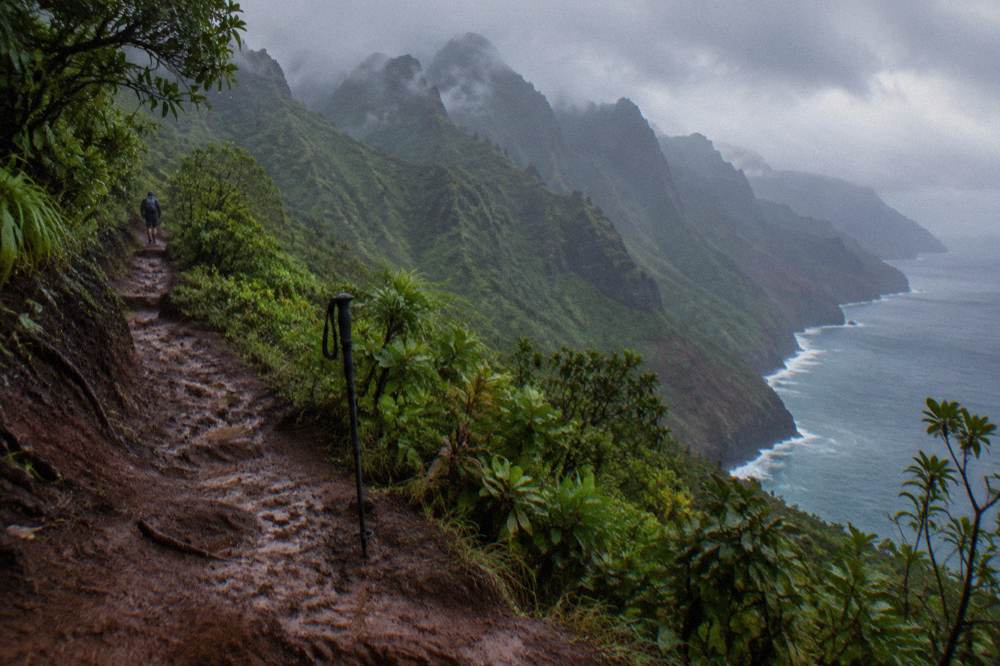 Tall green sea cliffs rising from blue ocean along a rugged coastline