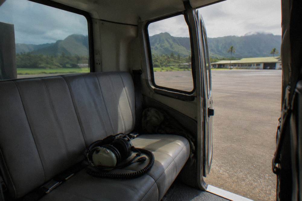 A helicopter cabin interior with headset on an empty seat