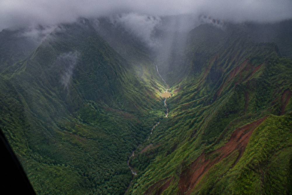Clouds drifting over the wet interior mountains of Kauai seen from the air