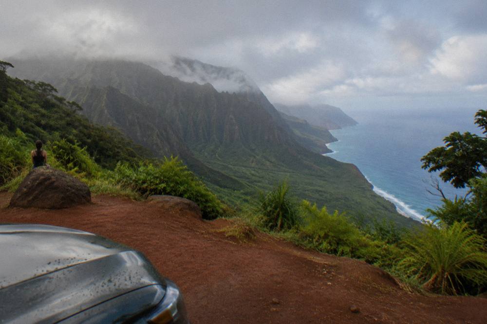 Green mountain valley opening onto the ocean with mist on the ridges