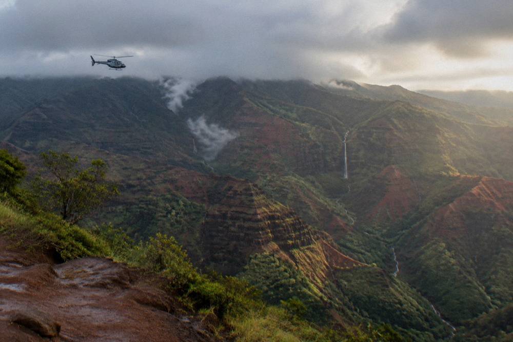 Morning light on canyon ridges with low clouds resting on distant summit slopes