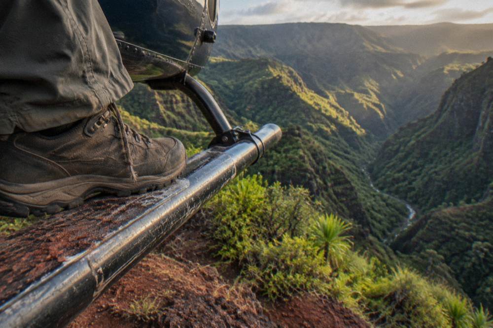Sturdy closed-toe shoes on a helicopter landing skid at a canyon rim